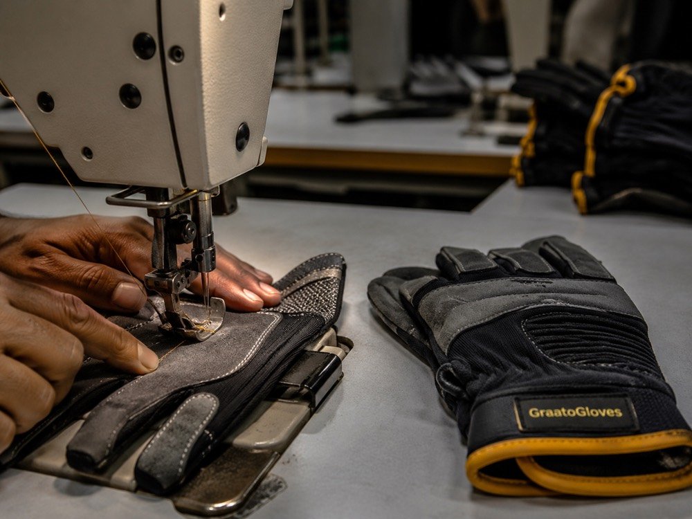 Close-up of work glove stitching on industrial sewing station